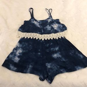 Navy blue tie die romper with lace detail.